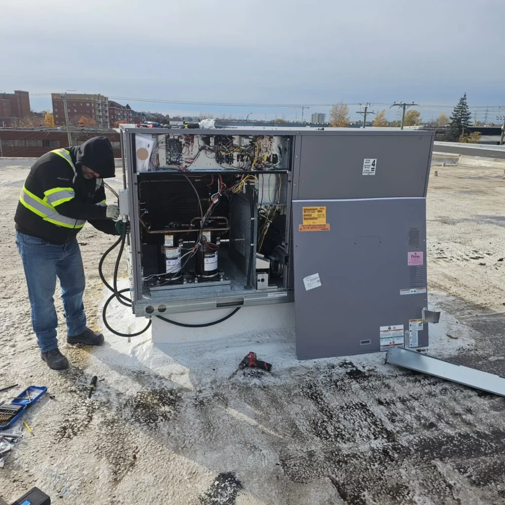 Electrician working on a 600 V heat pump on a cold November day