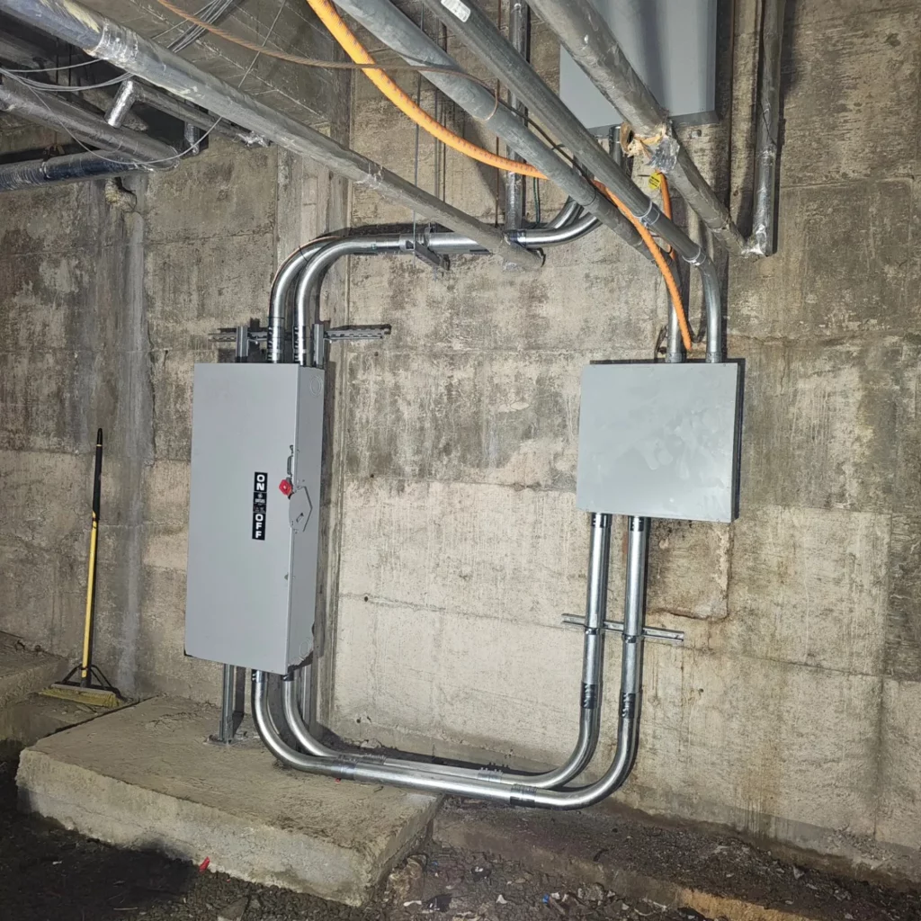 New conduit runs feeding the relocated 600 V service entrance