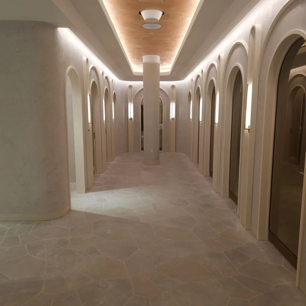 Store corridor at Dynamite Promenades St-Bruno with LED cove lighting and wall sconces