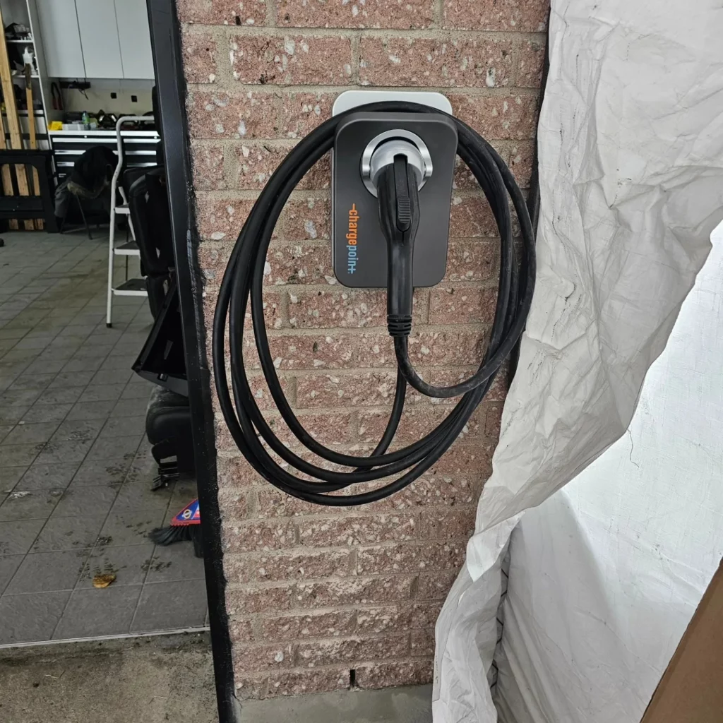 Level 2 electric vehicle charger installed on a home wall