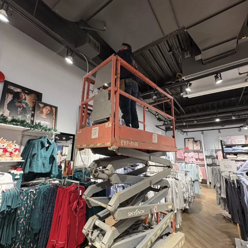 Electrician on a scissor lift installing lighting overnight at La Vie en Rose, Ottawa